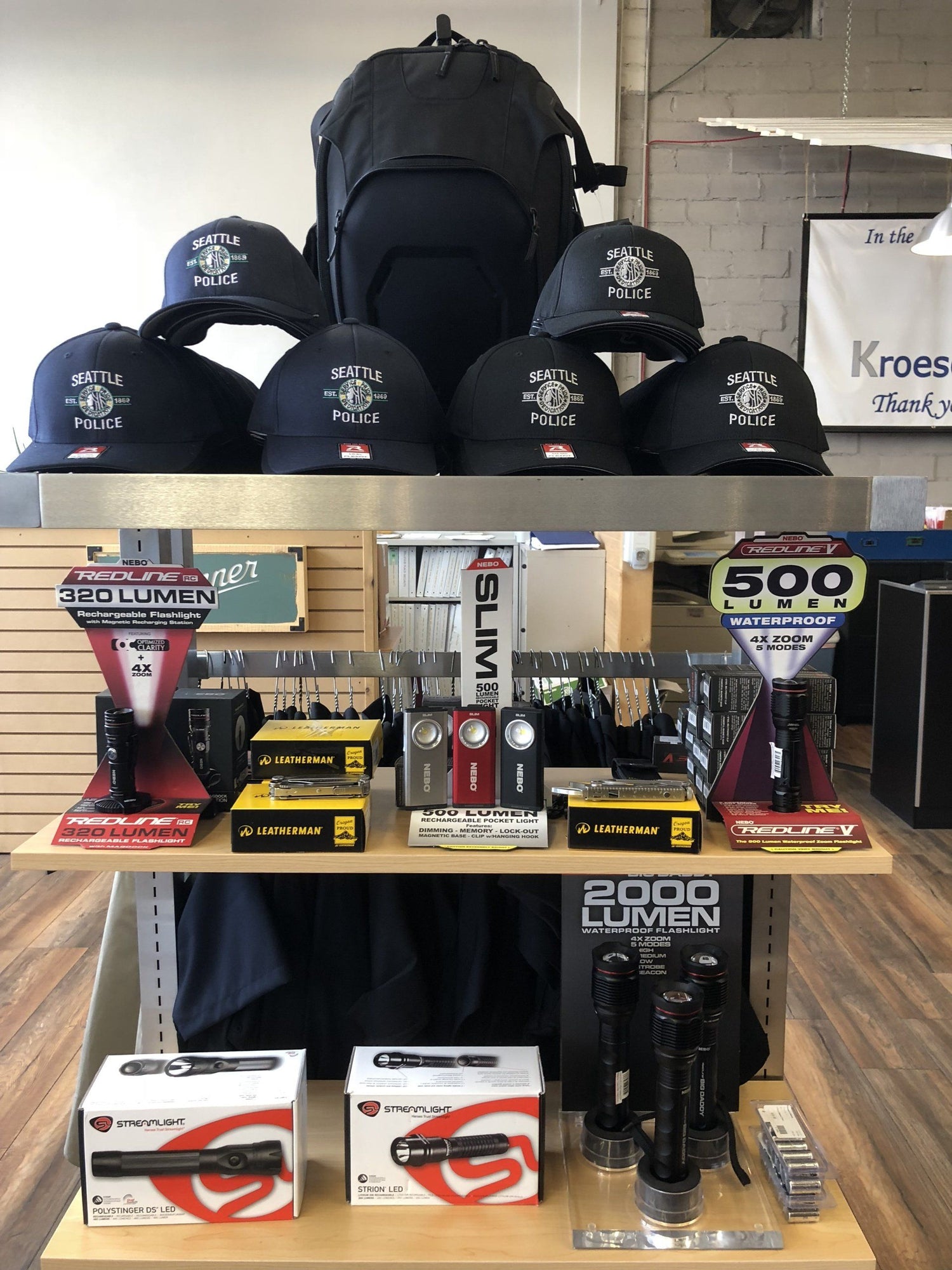 Kroesens merchandise on shelves, police hats, flashlights